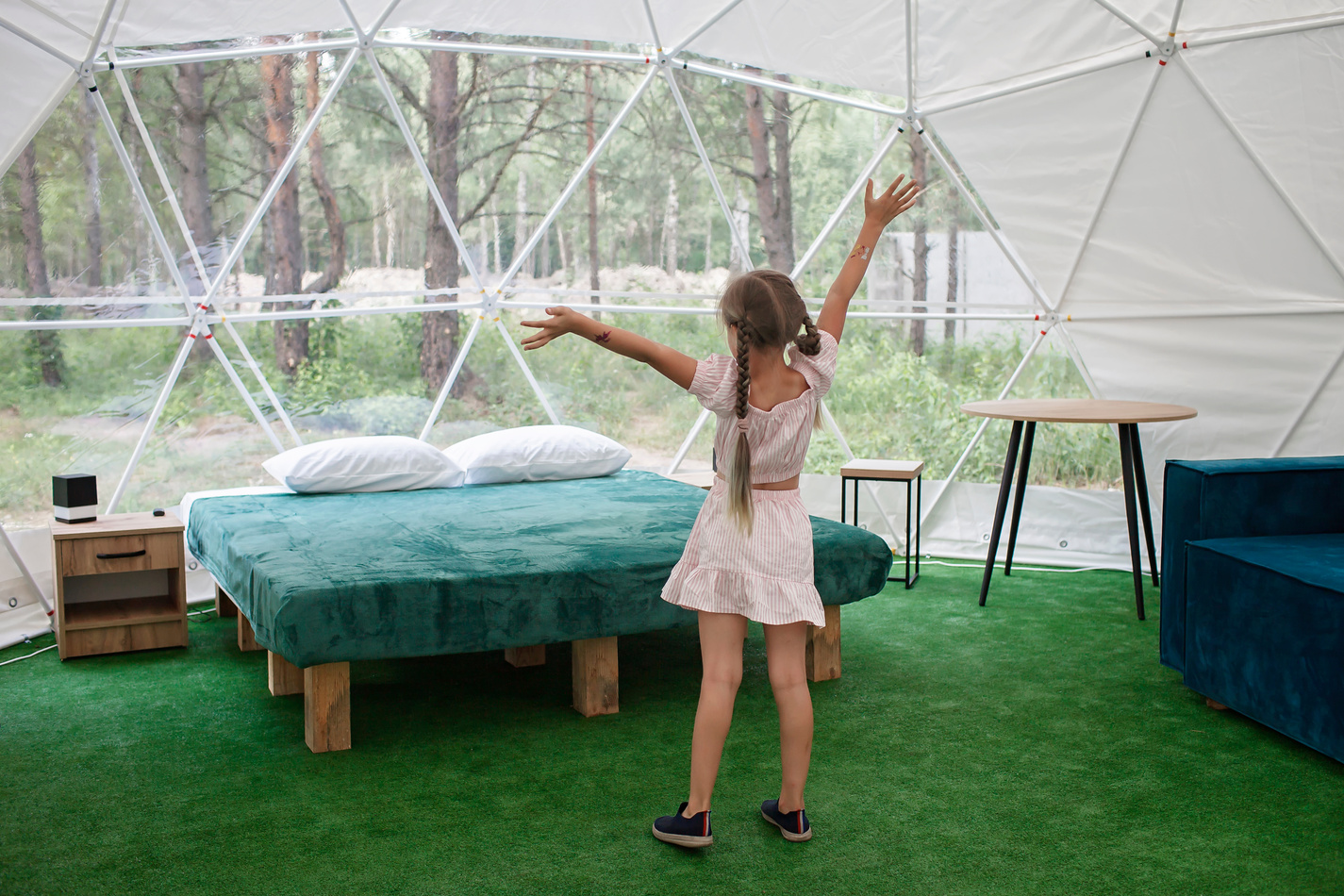 Young Girl Glamping in Transparent Bell Tent